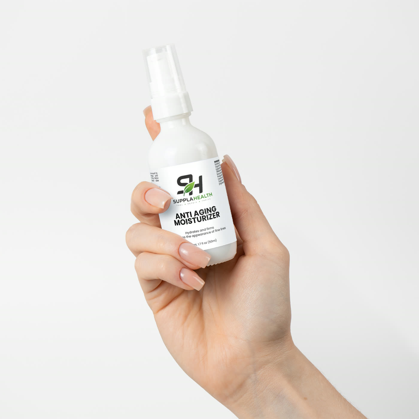 The bottle held in one hand, showing its size